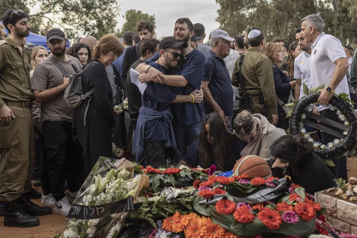 Relatives and friends mourn at the funeral of Alon Shamriz, who was kidnapped by Hamas and mistakenly killed by Israeli troops, in Shefayim, Israel.