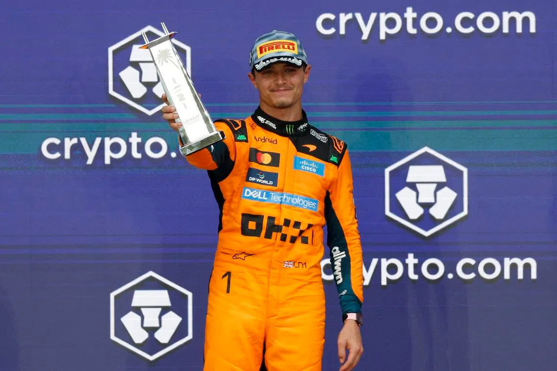Formula One F1 - Miami Grand Prix - Miami International Autodrome, Miami, Florida, United States - May 3, 2026 McLaren's Lando Norris celebrates with a trophy on the podium after finishing second place in the Miami Grand Prix REUTERS/Marco Bello