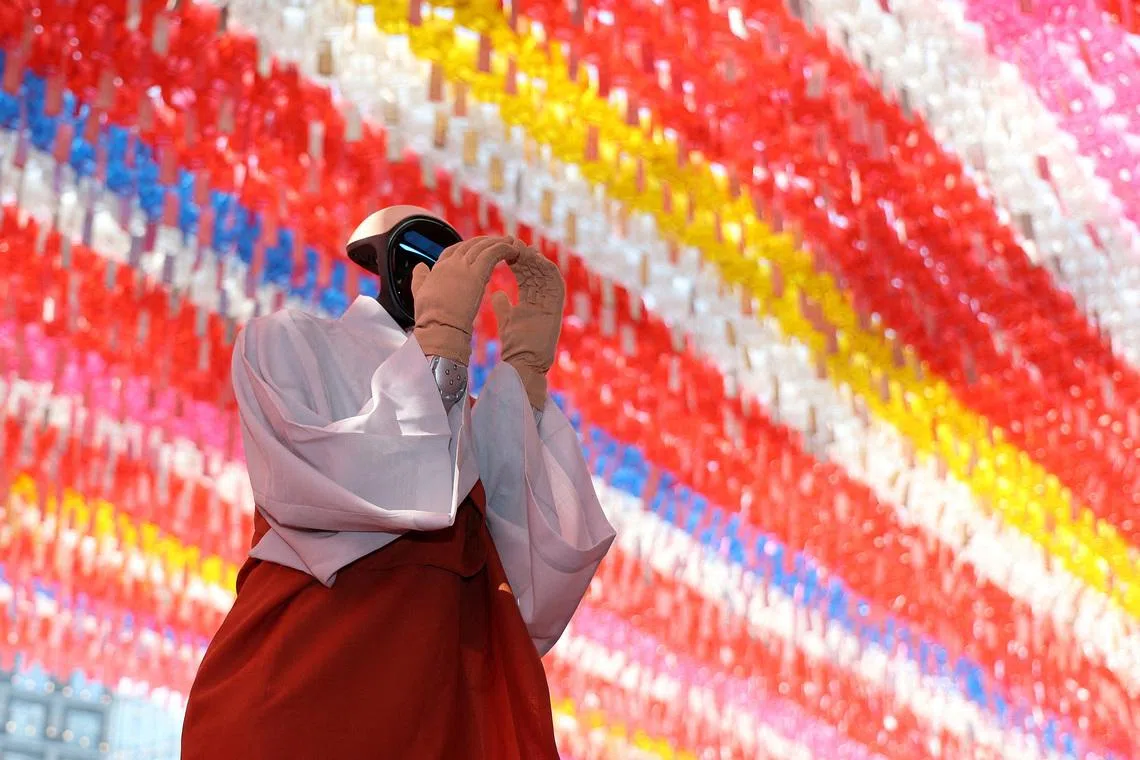 Humanoid robot Gabi folding its hands during a precept ceremony at a temple in Seoul, South Korea, on May 6, 2026. 