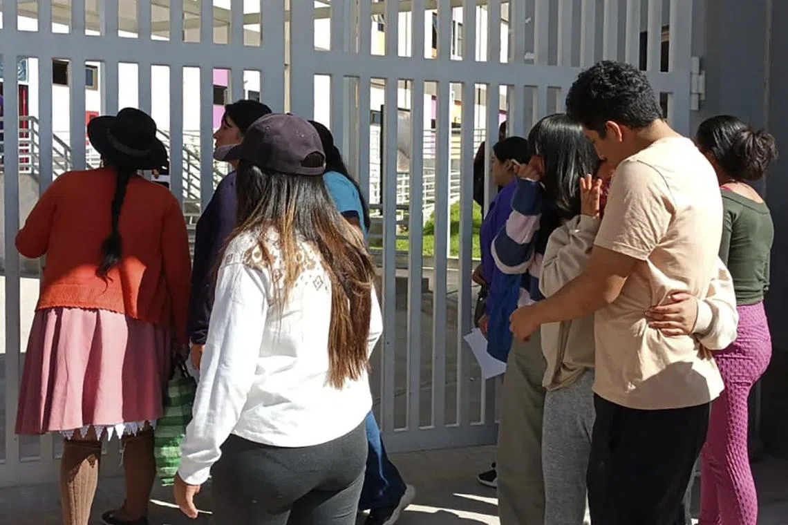 Victims' relatives awaiting news of their loved ones outside Mariscal Hospital, in Ayacucho, Peru, on July 16.