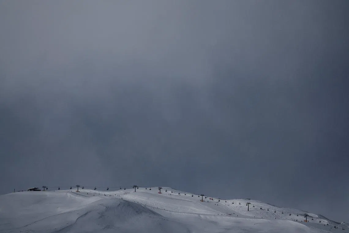 FILE PHOTO: A drone view shows cable cars operating above snow-covered ski slopes, ahead of the 2026 Milan Cortina Olympic games, in Livigno, Italy, January 9, 2026, REUTERS/Yara Nardi   /File Photo