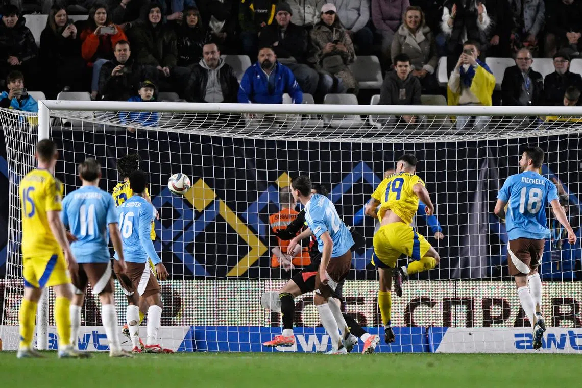 Soccer Football - Nations League - Play-offs - First Leg - Ukraine v Belgium - Estadio Nueva Condomina, Murcia, Spain - March 20, 2025 Ukraine's Illia Zabarnyi scores their third goal REUTERS/Pablo Morano