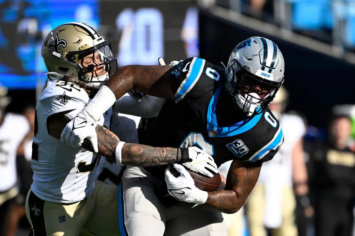 Nov 3, 2024; Charlotte, North Carolina, USA; Carolina Panthers tight end Ja'Tavion Sanders (0) with the ball as New Orleans Saints safety Tyrann Mathieu (32) defends in the third quarter at Bank of America Stadium. Mandatory Credit: Bob Donnan-Imagn Images/ File Photo