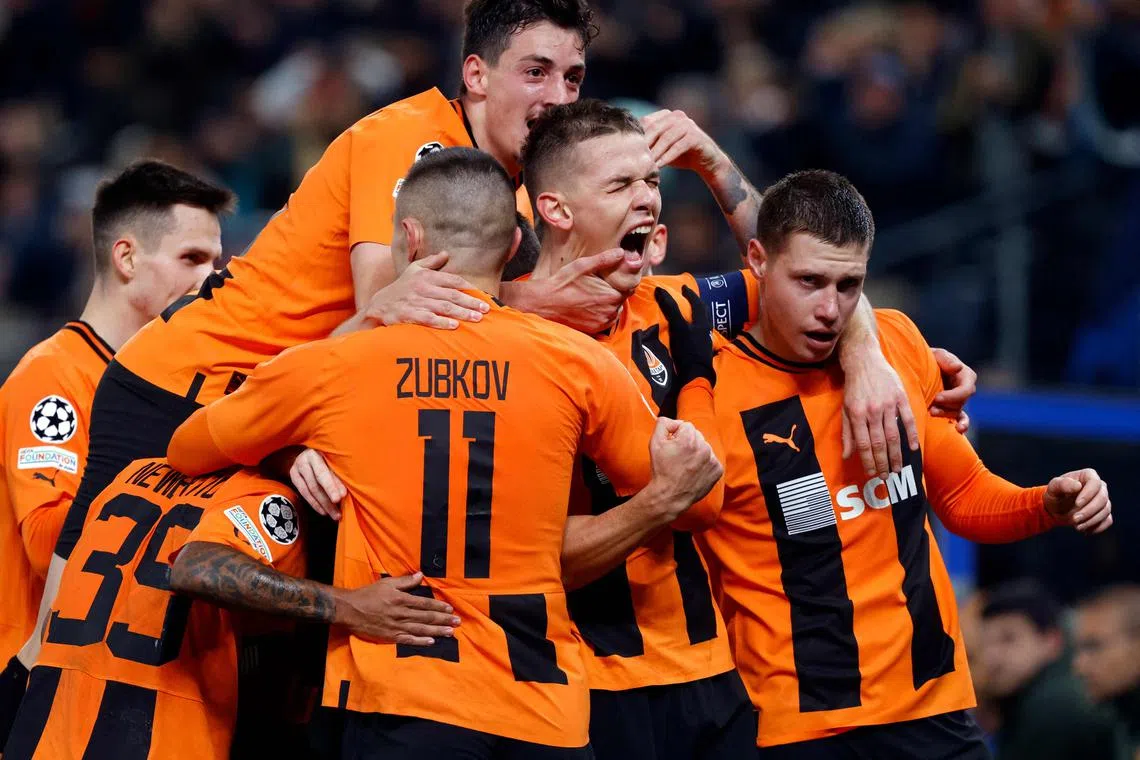 Shakhtar Donetsk players celebrate the only goal of the match, from Ukrainian forward Danylo Sikan (second from right).