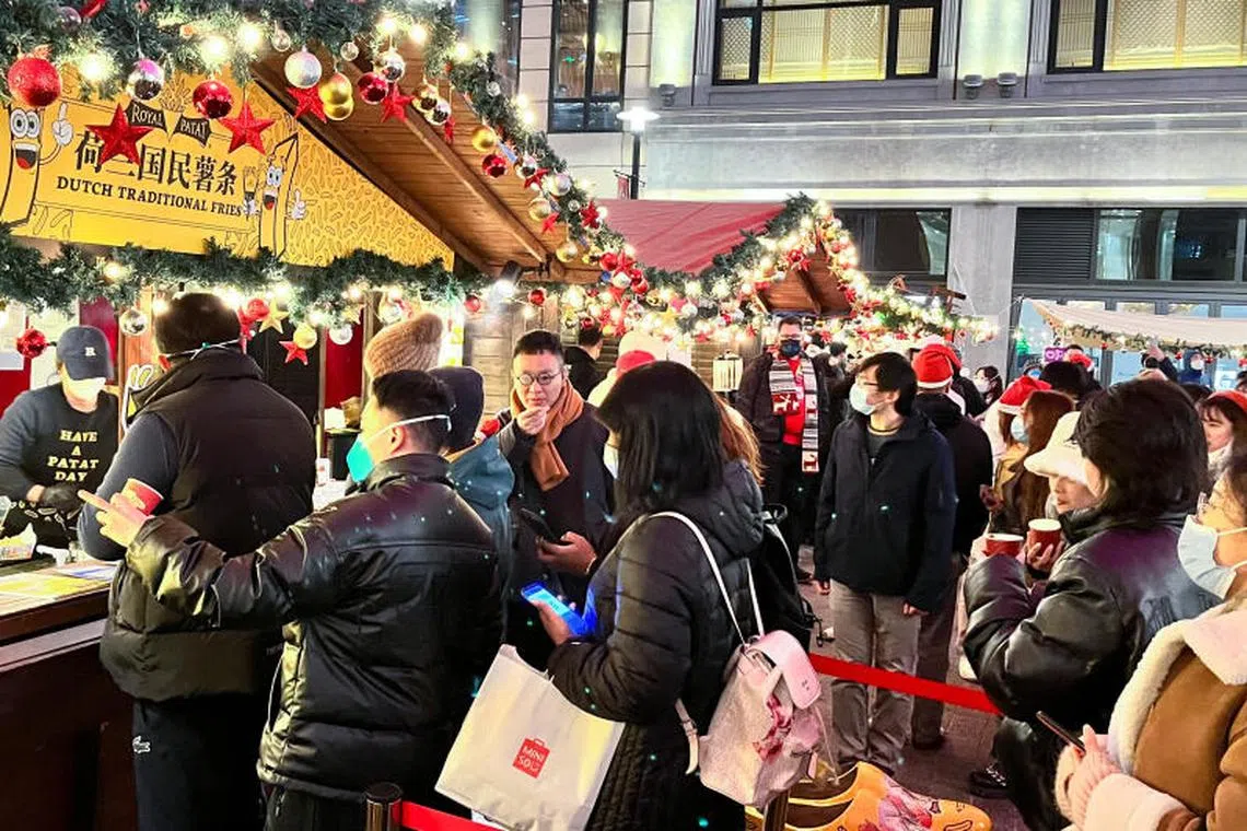 People visit a Christmas market in Shanghai, on Dec 24, 2022.