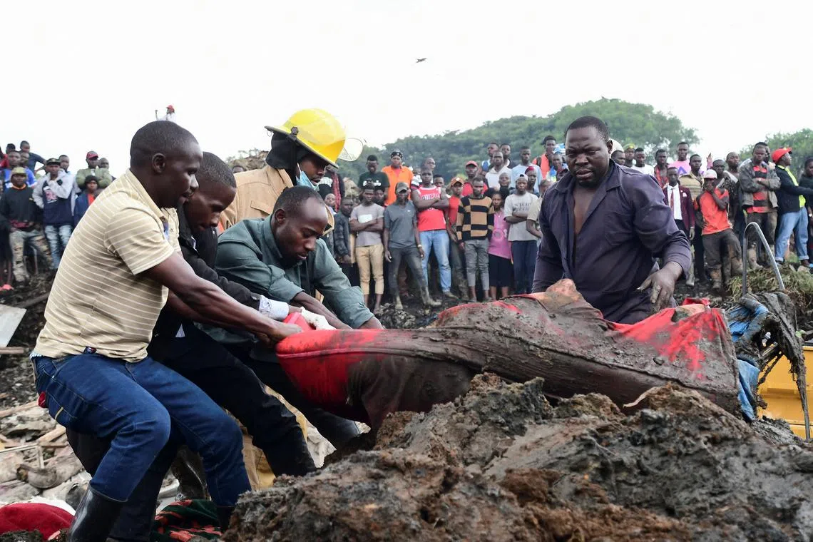 Volunteers remove rubble to search for the bodies of residents killed by a landslide due to heavy rainfall in a landfill known as Kiteezi that serves as garbage dumping site, in the Lusanja village, outside Kampala, Uganda August 10, 2024. REUTERS/Abubaker Lubowa