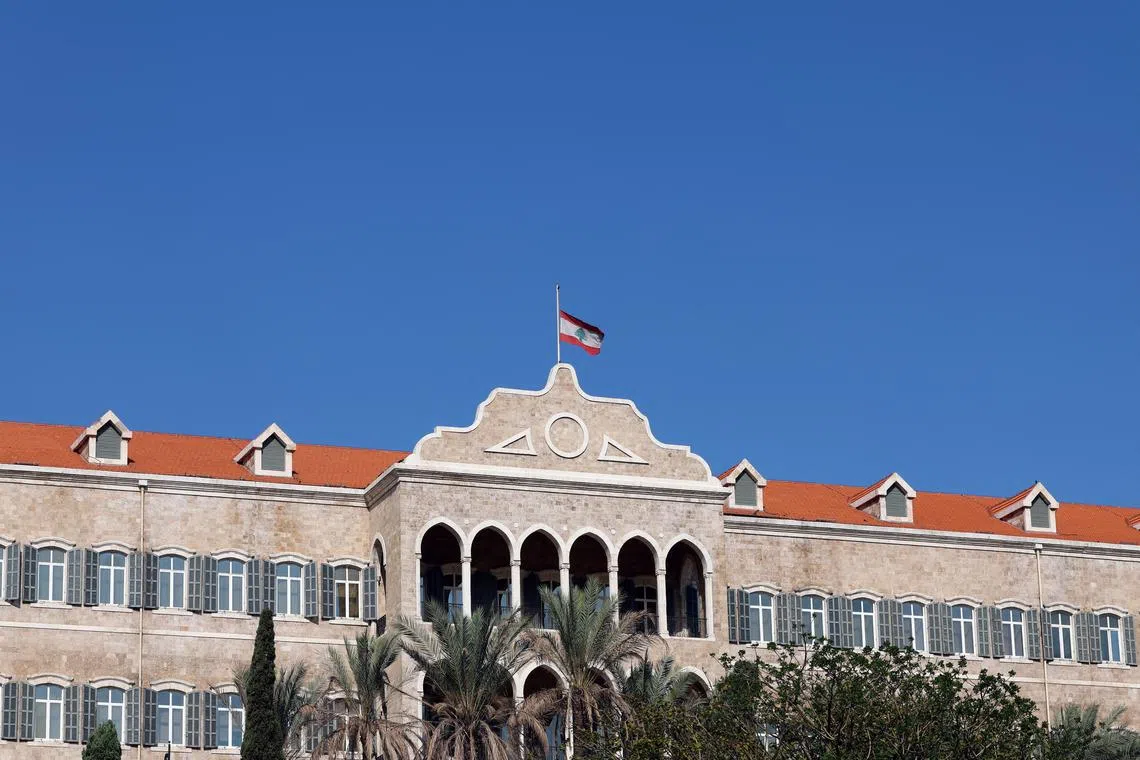 A Lebanese national flag flies at half-mast outside the government palace on the first of three days of mourning after Hezbollah leader Sayyed Hassan Nasrallah was killed in an Israeli air strike on Friday, in Beirut, Lebanon September 30, 2024. REUTERS/Mohamed Azakir