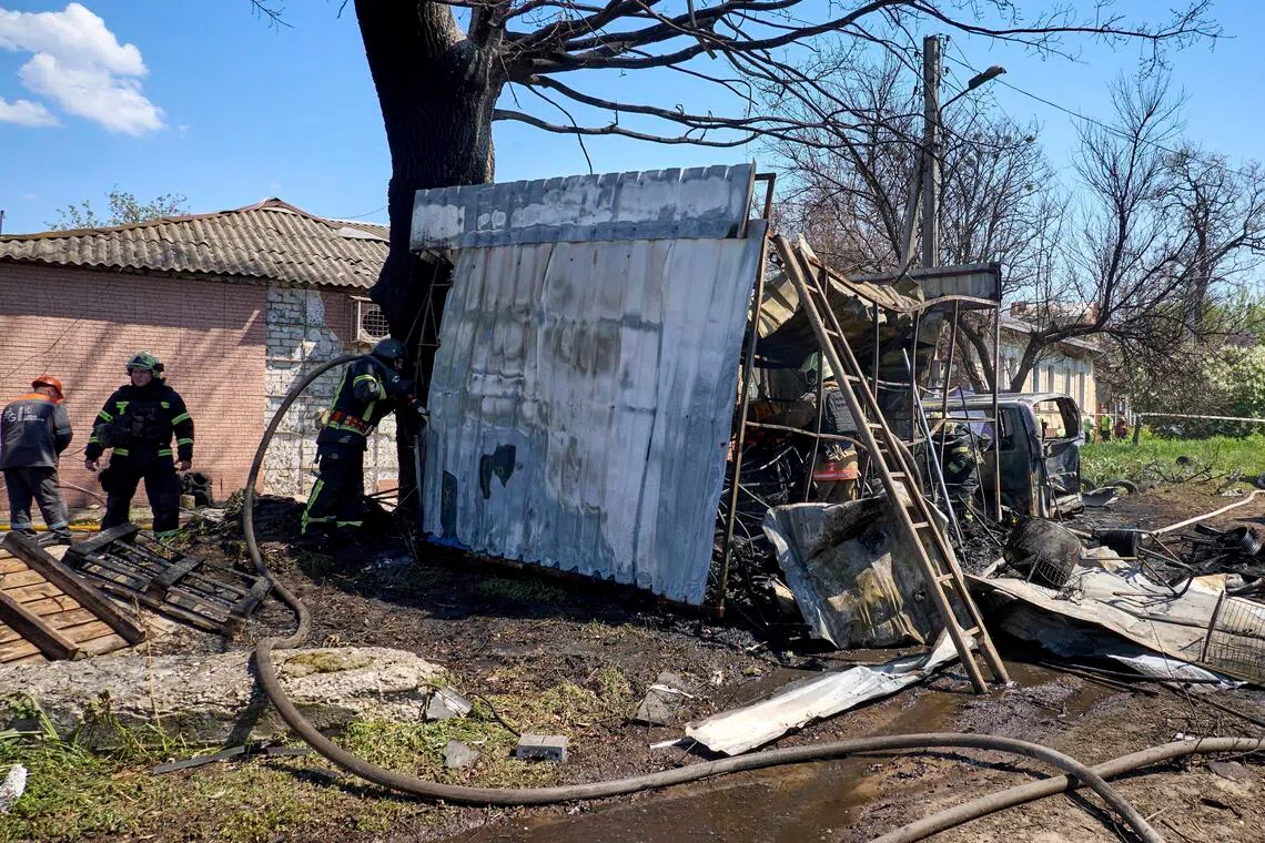 Ukrainian rescuers working at the site of a Russian strike on a residential area in Kharkiv, Ukraine, on May 7.