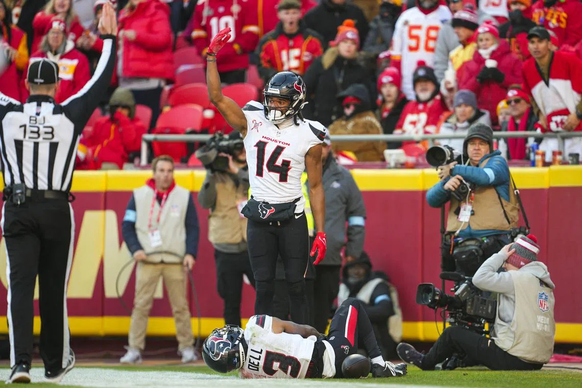 FILE PHOTO: Dec 21, 2024; Kansas City, Missouri, USA; Houston Texans wide receiver Jared Wayne (14) calls for medical staff after an injury to wide receiver Tank Dell (3) during the second half against the Kansas City Chiefs at GEHA Field at Arrowhead Stadium. Mandatory Credit: Jay Biggerstaff-Imagn Images/File photo