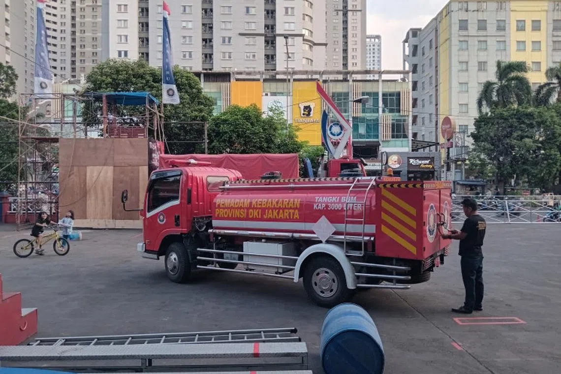 A firefighter prepares a fire truck on July 30 at the West Jakarta Fire and Rescue Agency.