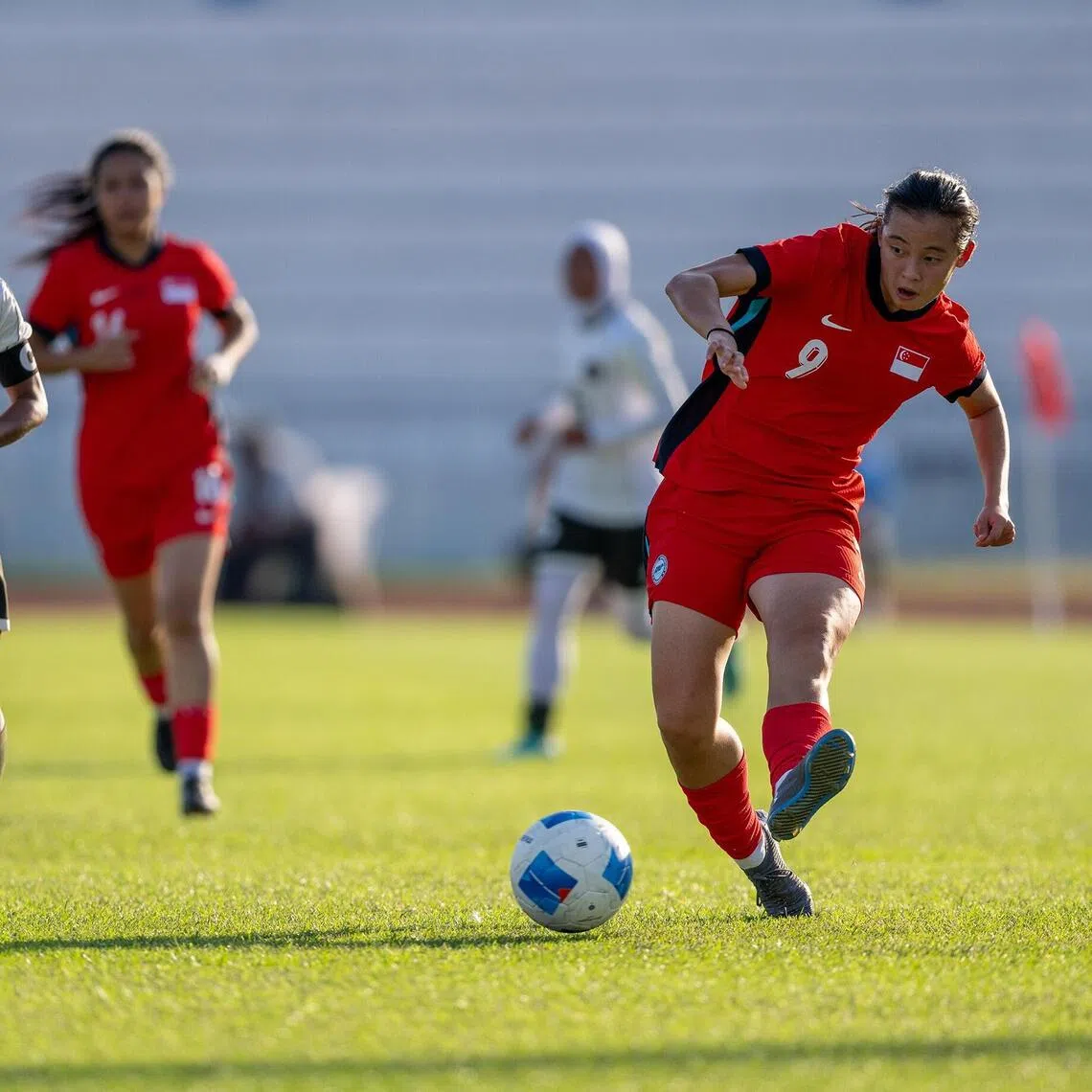 Danelle Tan plays a pass that leads to the Lionesses' goal in their match against Indonesia in their SEA Games women's football tournament opener on Dec 7. 
Credit: Singapore National Olympic Council