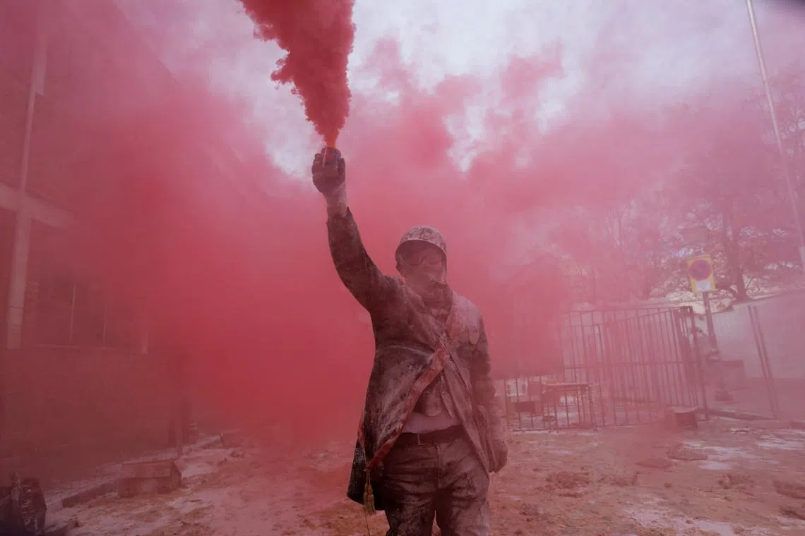 A reveller participating in the traditional "Els Enfarinats" (The Floured) festival in Ibi, Spain, Dec 28, 2023. 