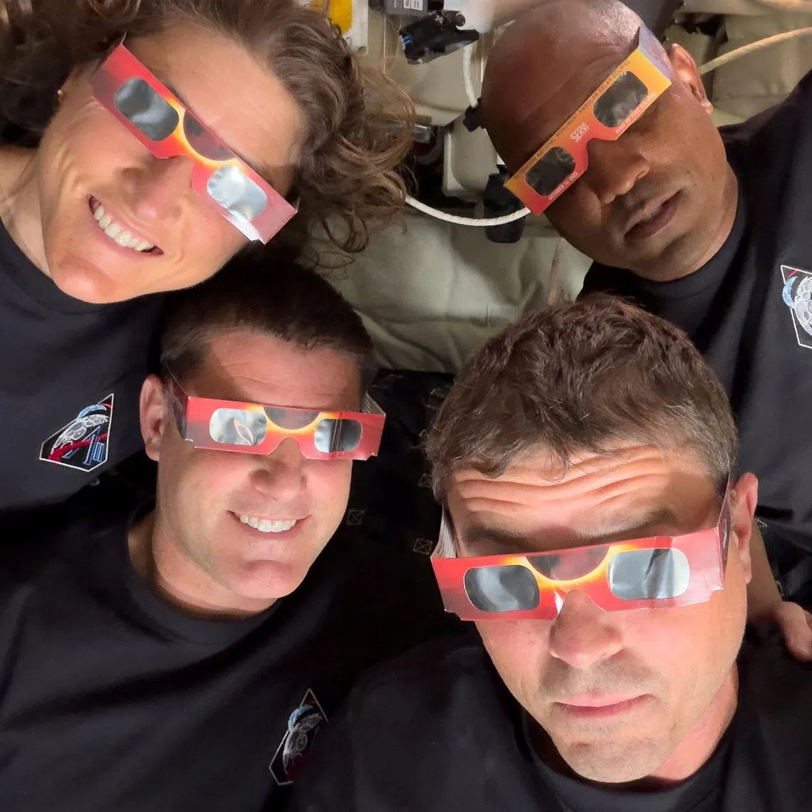 The Artemis II crew of NASA astronauts Christina Koch, Reid Wiseman, Victor Glover and Canadian Space Agency (CSA) astronaut Jeremy Hansen with their eclipse glasses used to protect their eyes for the Orion spacecraft's flyby of the Moon on April 6.