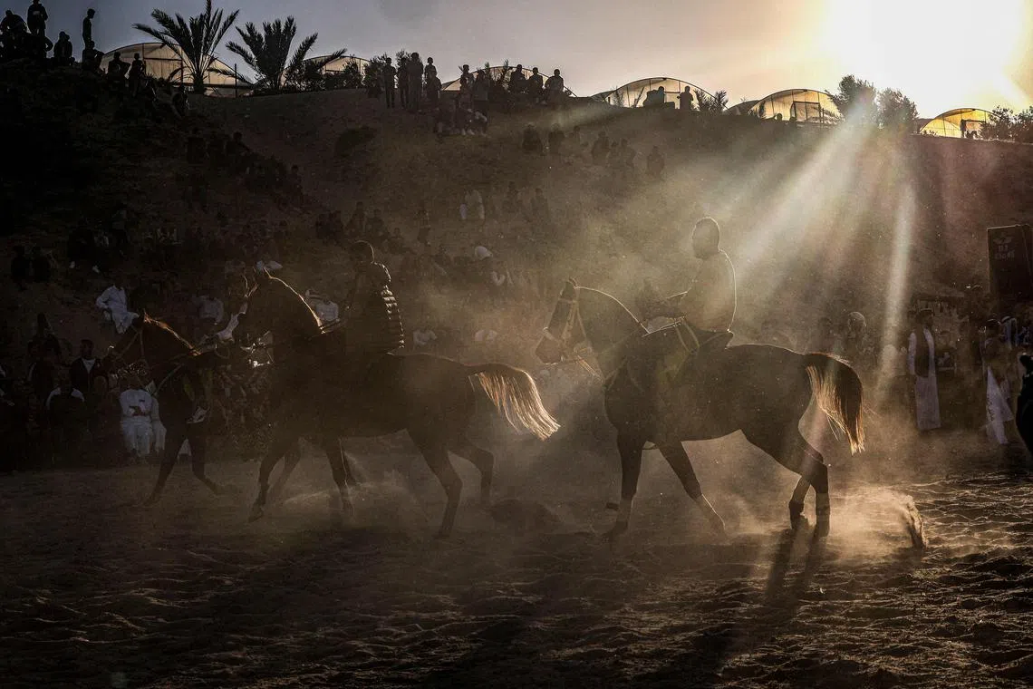 Palestinian horsemen show off their skills during a traditional wedding ceremony in Khan Yunis in the southern Gaza Strip, on November 7, 2022. 