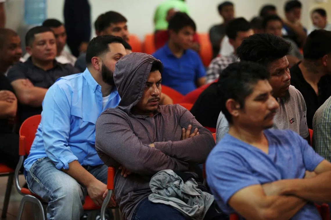 FILE PHOTO: Deportees wait to be processed at an immigration facility after a flight carrying illegal immigrants from the U.S. arrived in San Salvador, El Salvador, June 22, 2018. REUTERS/Jose Cabezas/File Photo