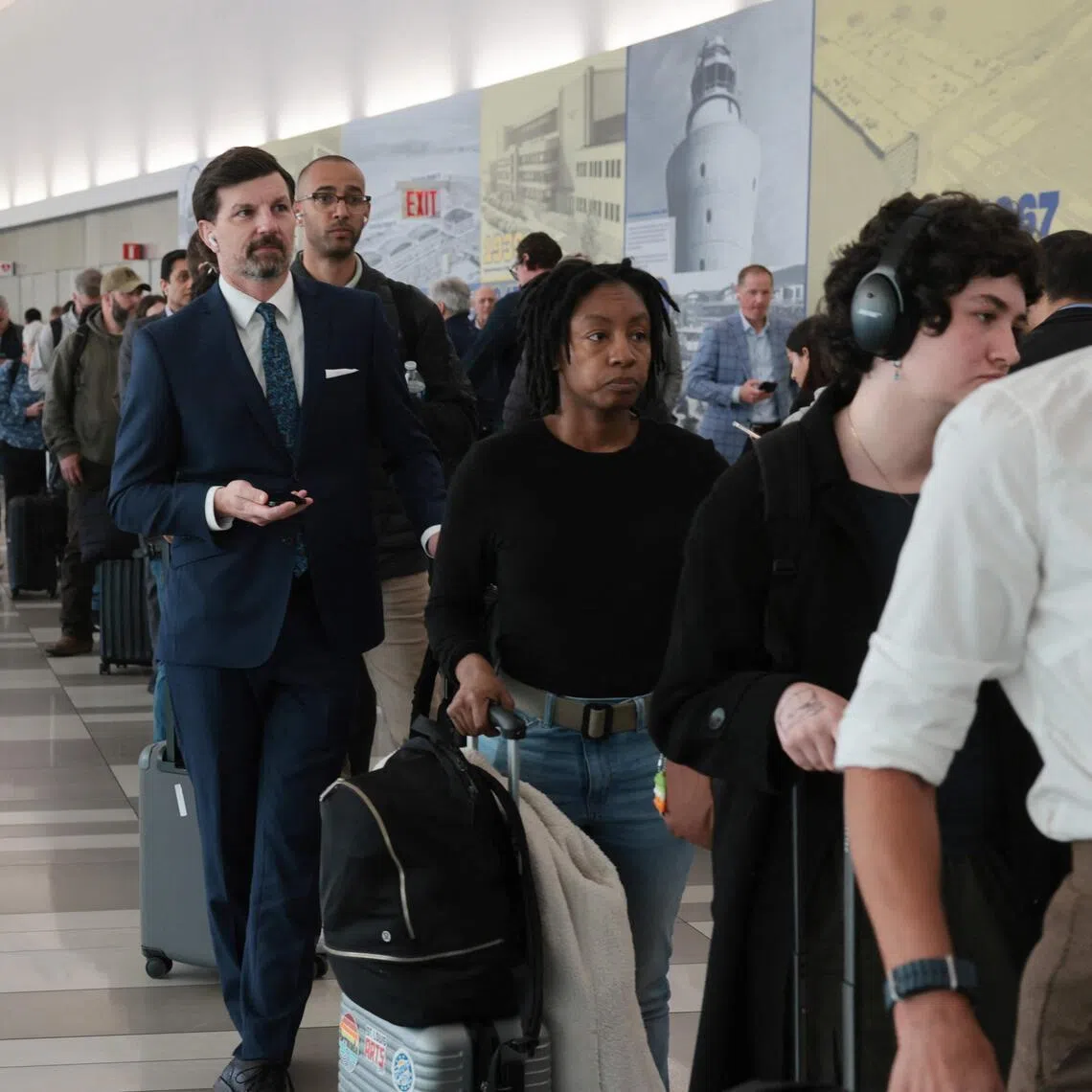 People wait in long security lines at LaGuardia Airport on March 25, 2026 as hundreds of TSA agents have quit or are working without pay during a partial government shutdown. 