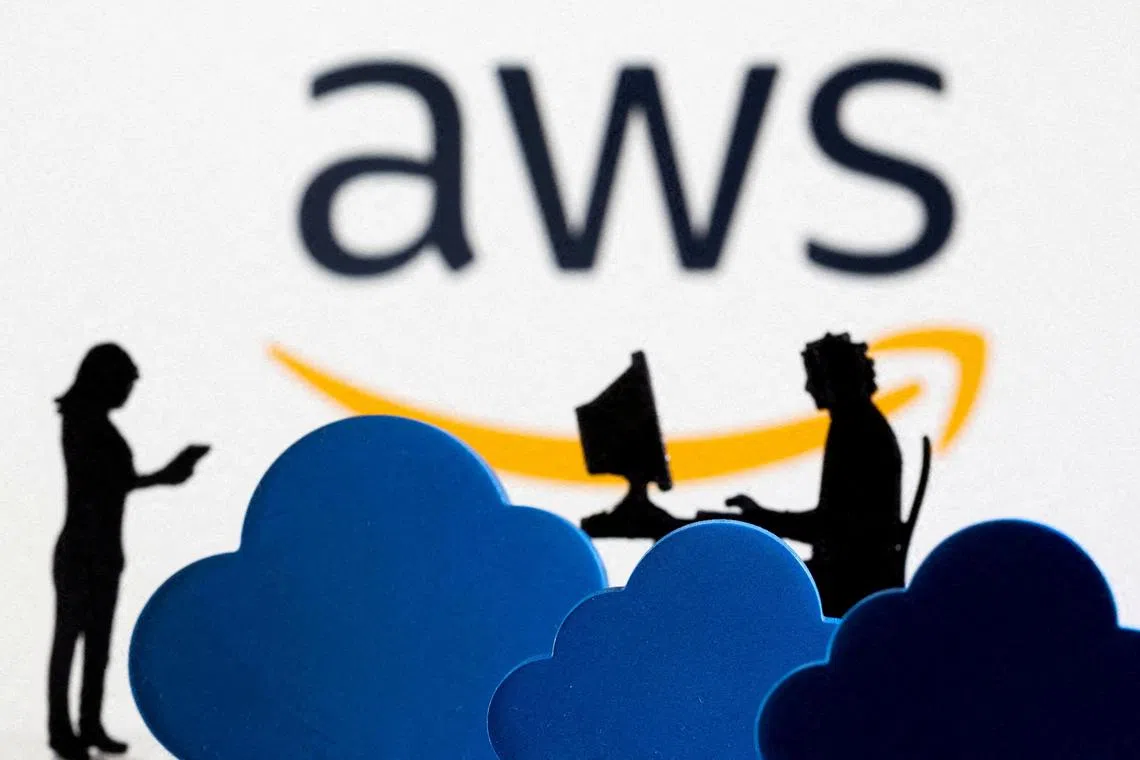 FILE PHOTO: 3D printed clouds and figurines are seen in front of the AWS (Amazon Web Service) cloud service logo in this illustration taken February 8, 2022. REUTERS/Dado Ruvic/File Photo