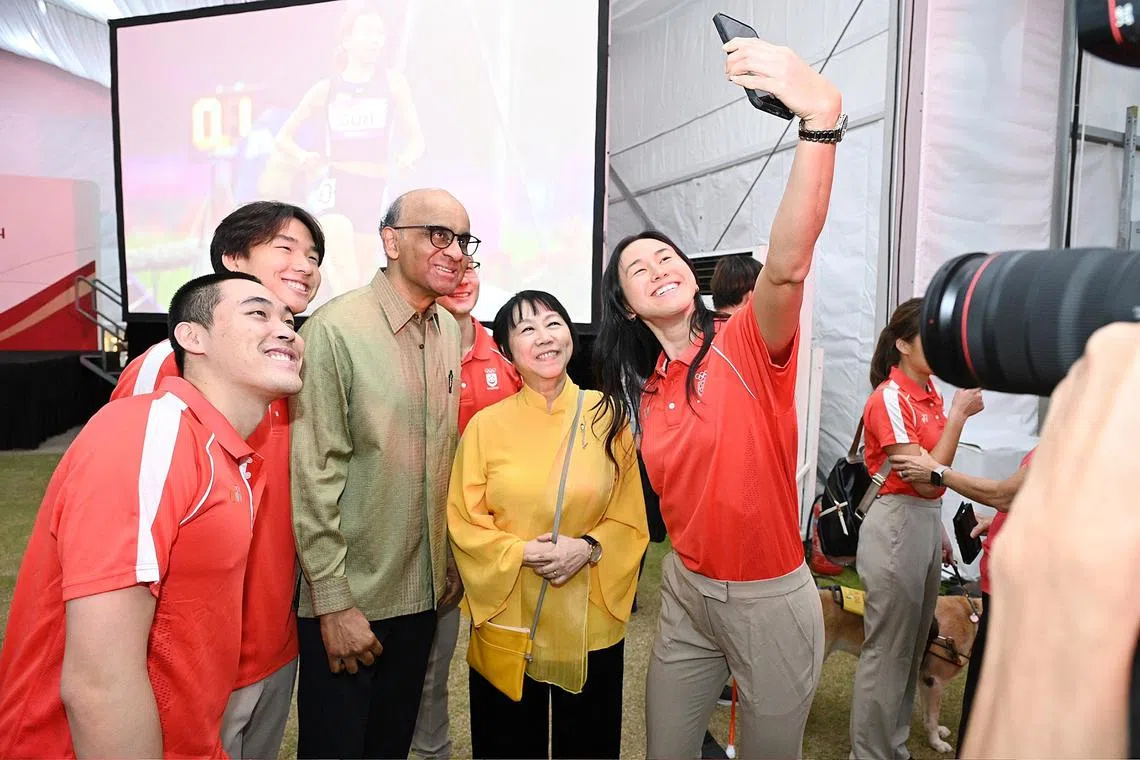 President Tharman Shanmugaratnam and Mrs Jane Ittogi Shanmugaratnam pose for a wefie with Quah Ting Wen at the Team Singapore reception. 
