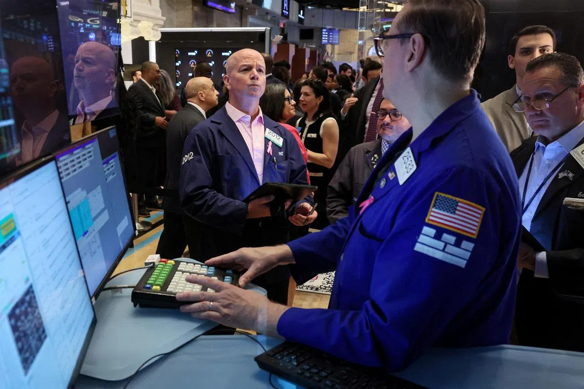 Traders work on the floor of the New York Stock Exchange, in New York City.