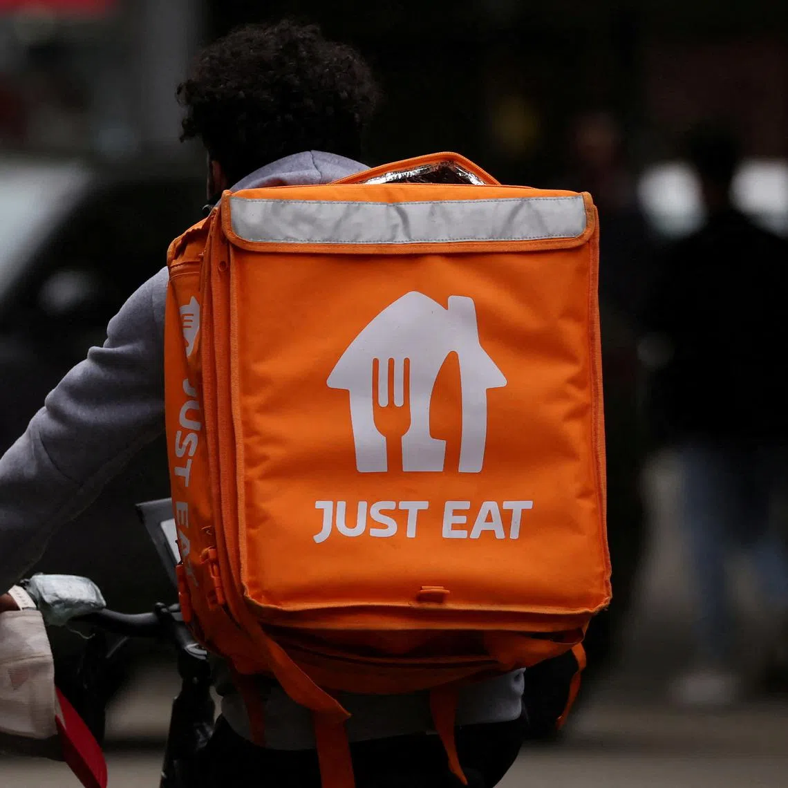 FILE PHOTO: A Just Eat delivery rider cycles through Manchester, Britain, August 23, 2023. REUTERS/Phil Noble/File Photo