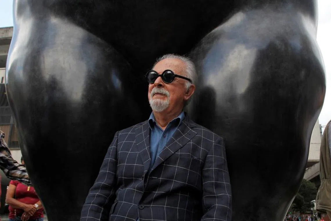 Colombian painter and sculptor Fernando Botero sits underneath one of his sculptures during a stroll with Medellin's Mayor Federico Gutierrez (not pictured) in Medellin, Colombia January 27, 2017. REUTERS/Fredy Builes/File photo