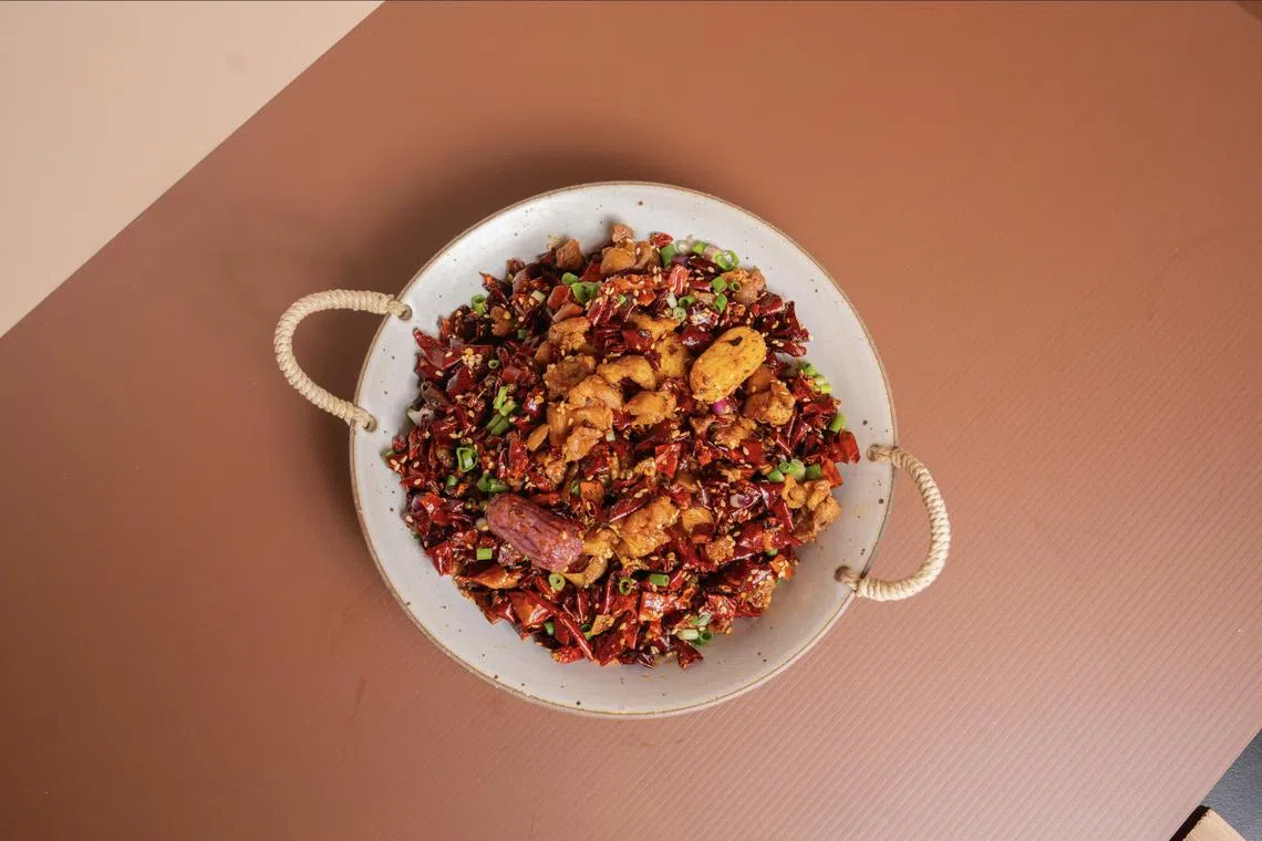 Classic spicy chilli chicken with cheesy rice cake from Chengdu Bowl.