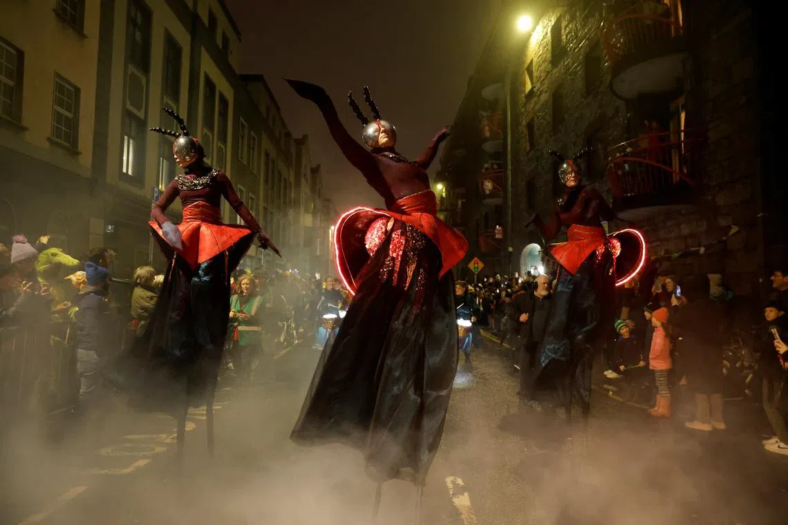 Performers the Macnas dance group during their Halloween parade called 'Alf's Journey', inspired by climate change and habitat loss, in Galway, Ireland, on Oct 27, 2024. 