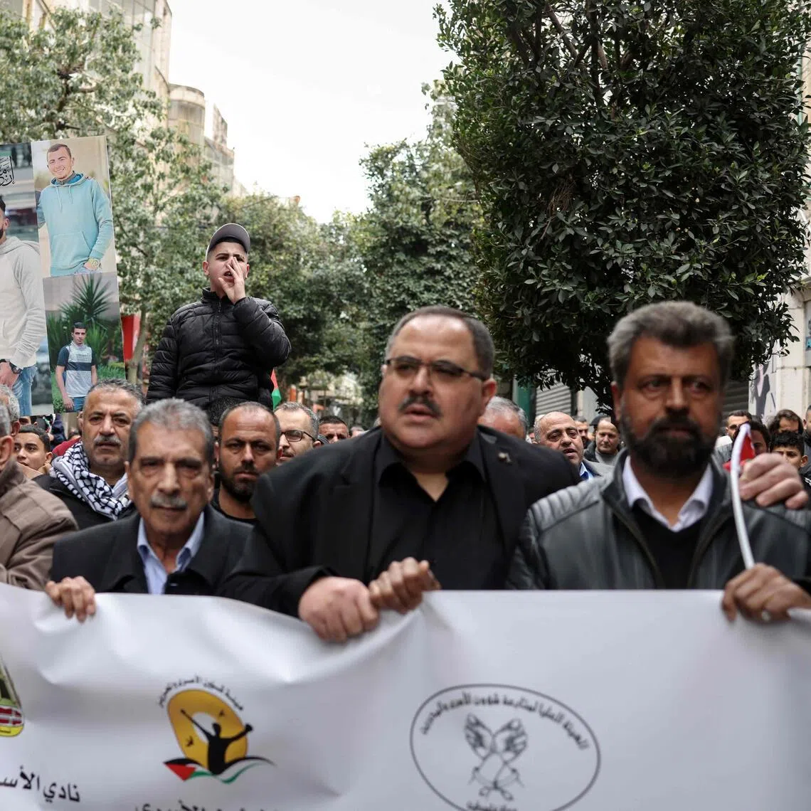 Palestinian demonstrators march in the occupied West Bank on April 1 during a protest against the Israeli Parliament's approval of a new death penalty Bill.
