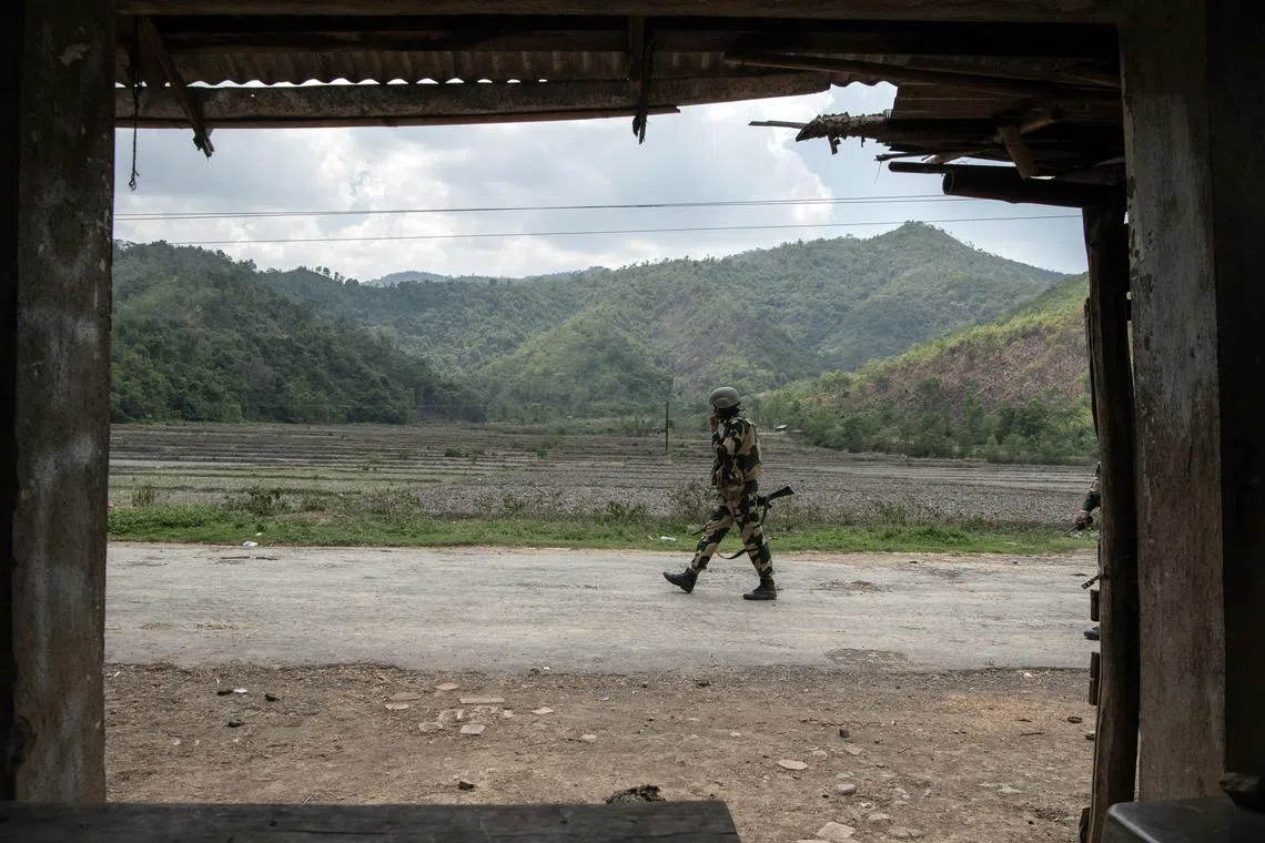 A member of the Border Security Force along the road of one of the last Meitei villages in Imphal East, in the Indian state of Manipur, June 1, 2023. An outburst of ethnic hatreds, led by the local government, has fractured an ancient kingdom and turned neighbors into enemies. (Saumya Khandelwal/The New York Times)