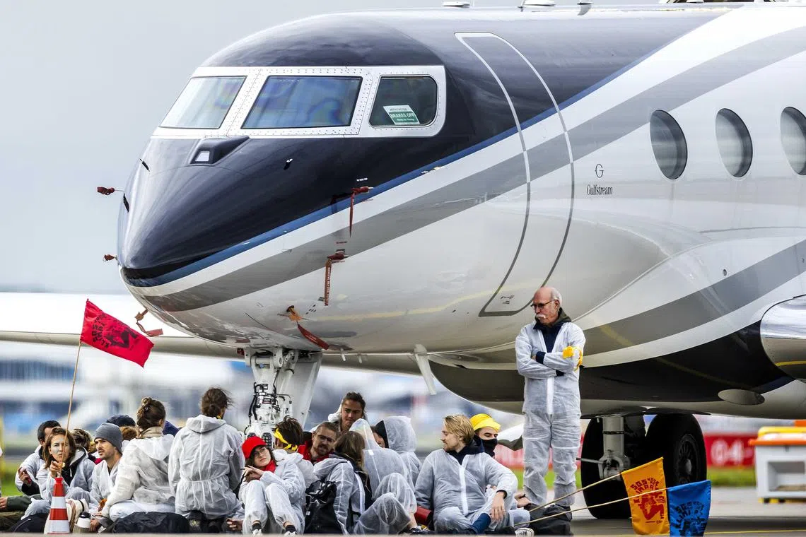 Activists stormed an area holding private jets at Amsterdam’s Schiphol Airport and stopped aircraft from leaving.