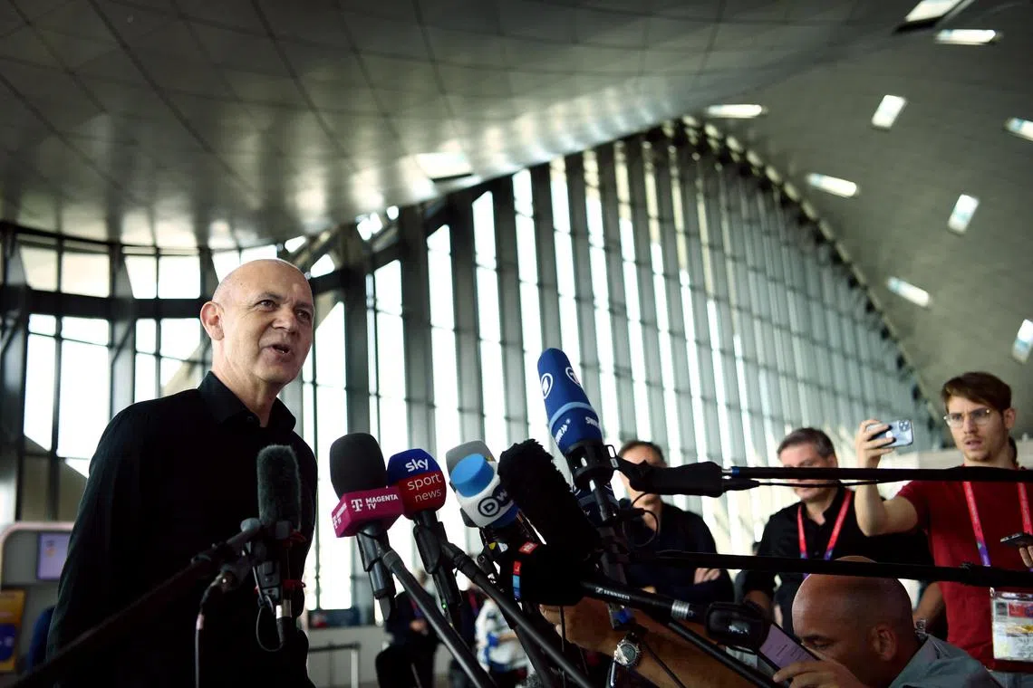 President of the German Football Association Bernd Neuendorf speaking to the media on Friday at the Hamad International Airport in Doha as Germany were preparing to fly home after being eliminated from the World Cup a day earlier. 