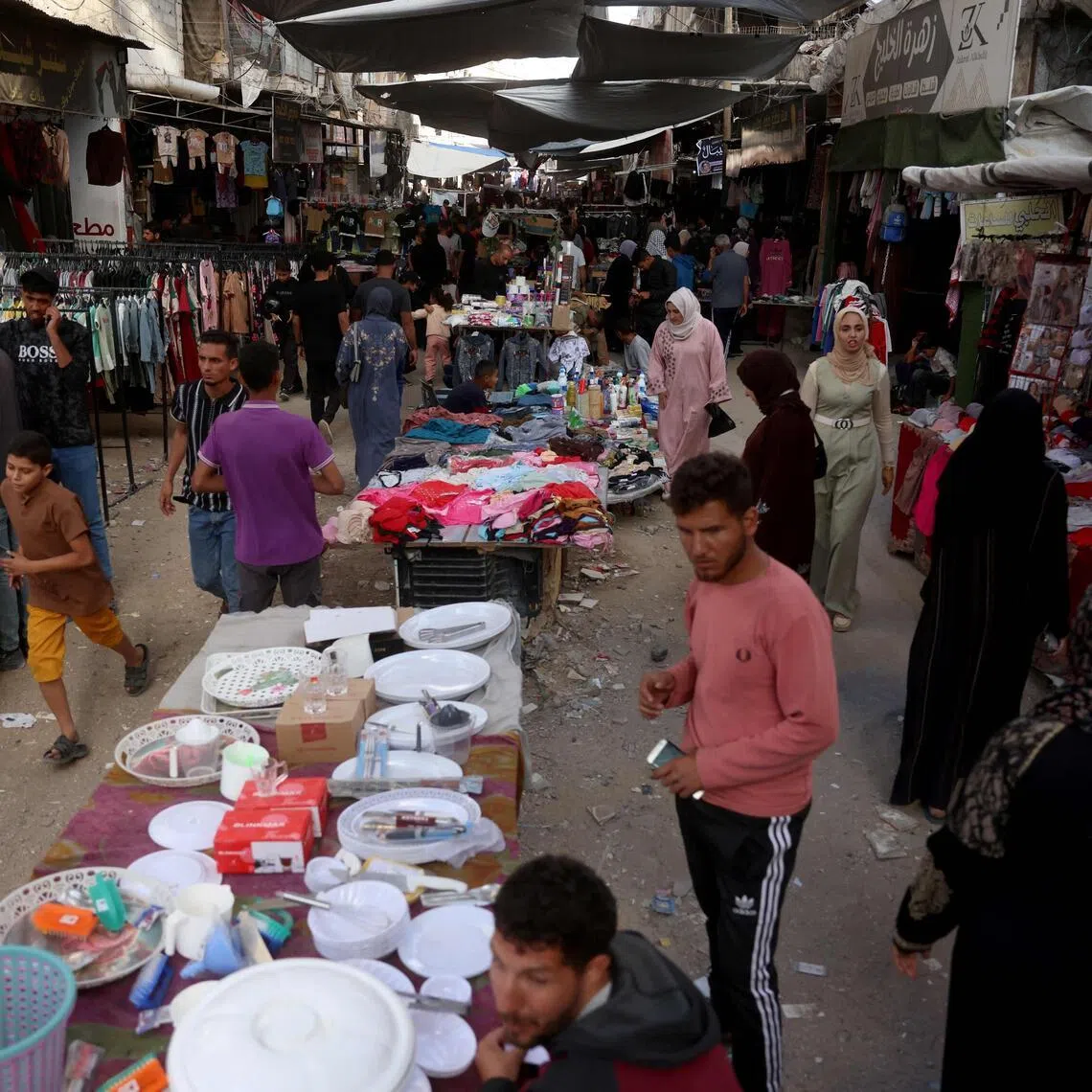 Palestinians shop on the eve of the Muslim holiday of Eid al-Adha, or Feast of Sacrifice, marking the end of the Hajj pilgrimage,  in Khan Yunis southern of Gaza Strip on May 26, 2026.