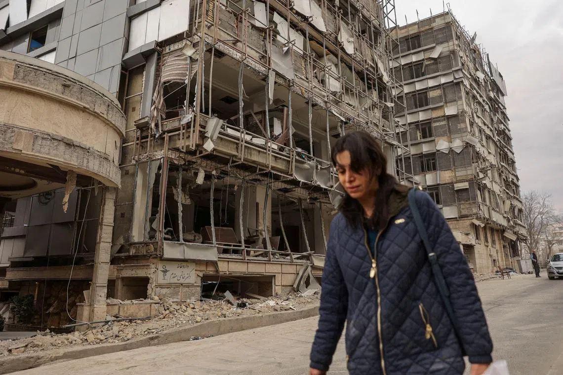 A woman walks on the street following an Israeli and U.S. strike on Gandhi Hotel Hospital, amid the U.S.-Israel conflict with Iran, in Tehran, Iran, March 2, 2026. Majid Asgaripour/WANA (West Asia News Agency) via REUTERS