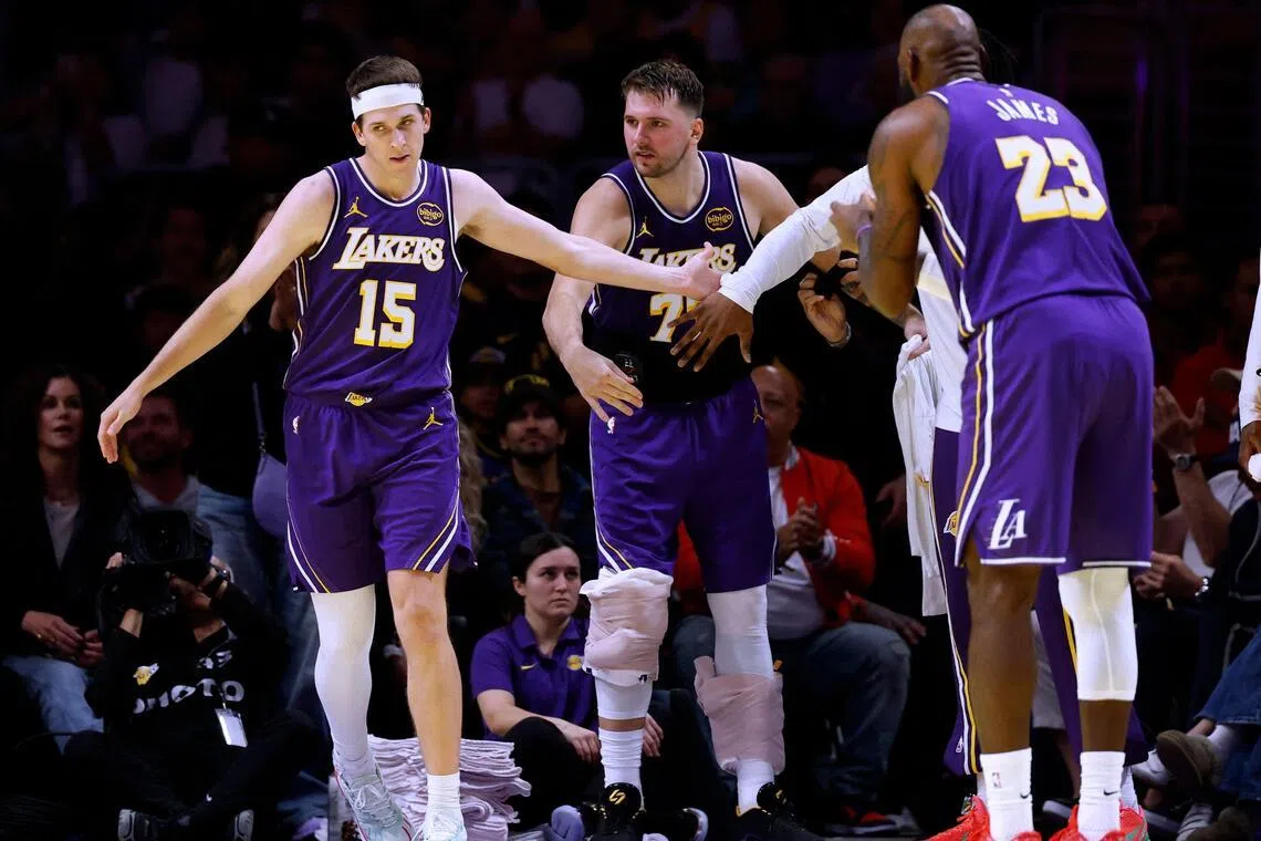 From left: Los Angeles Lakers' Austin Reaves celebrating his basket with Luka Doncic and LeBron James during their 135-118 win over the Los Angeles Clippers on Nov 25, 2025.