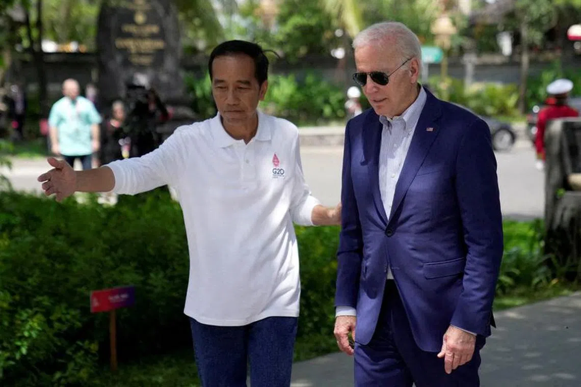 FILE PHOTO: Indonesian President Joko Widodo greets U.S. President Joe Biden upon his arrival for a mangrove planting event at Ngurah Rai Forest Park, on the sidelines of the G20 summit in Denpasar, Bali, Indonesia November 16, 2022. Dita Alangkara/Pool via REUTERS/File Photo