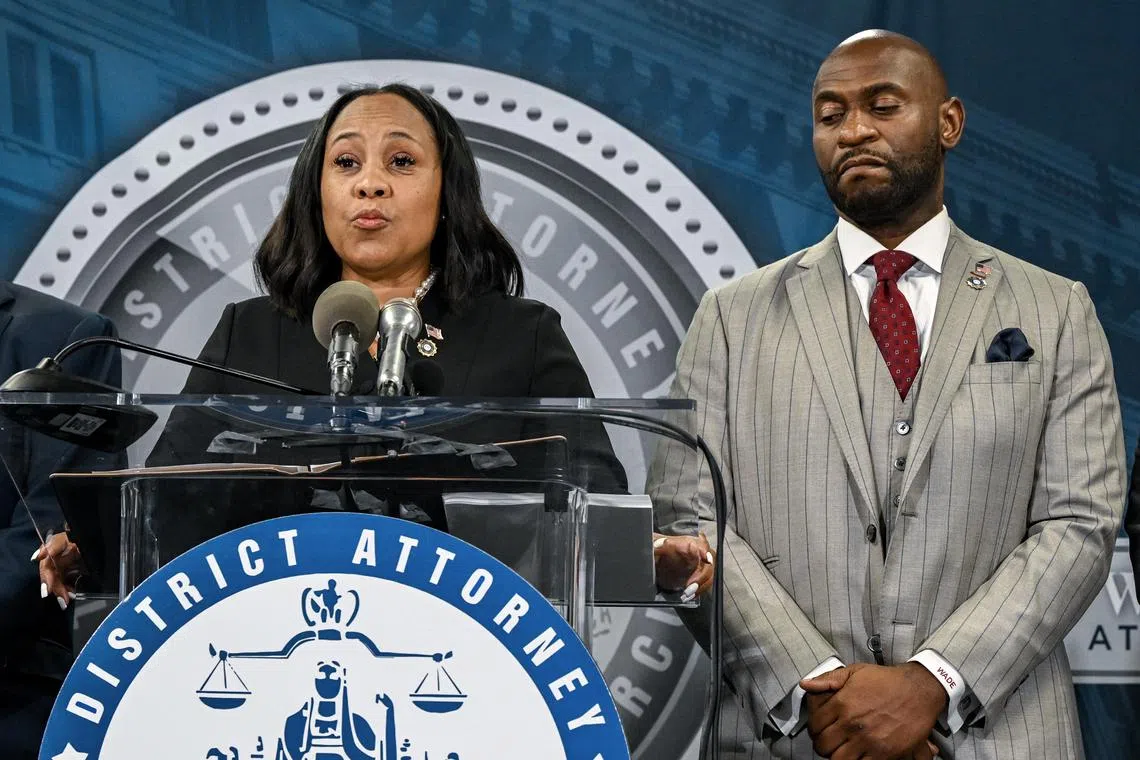 District attorney Fani Willis appears with special prosecutor Nathan Wade during a 2023 press briefing to announce the indictment of former US president Donald Trump.