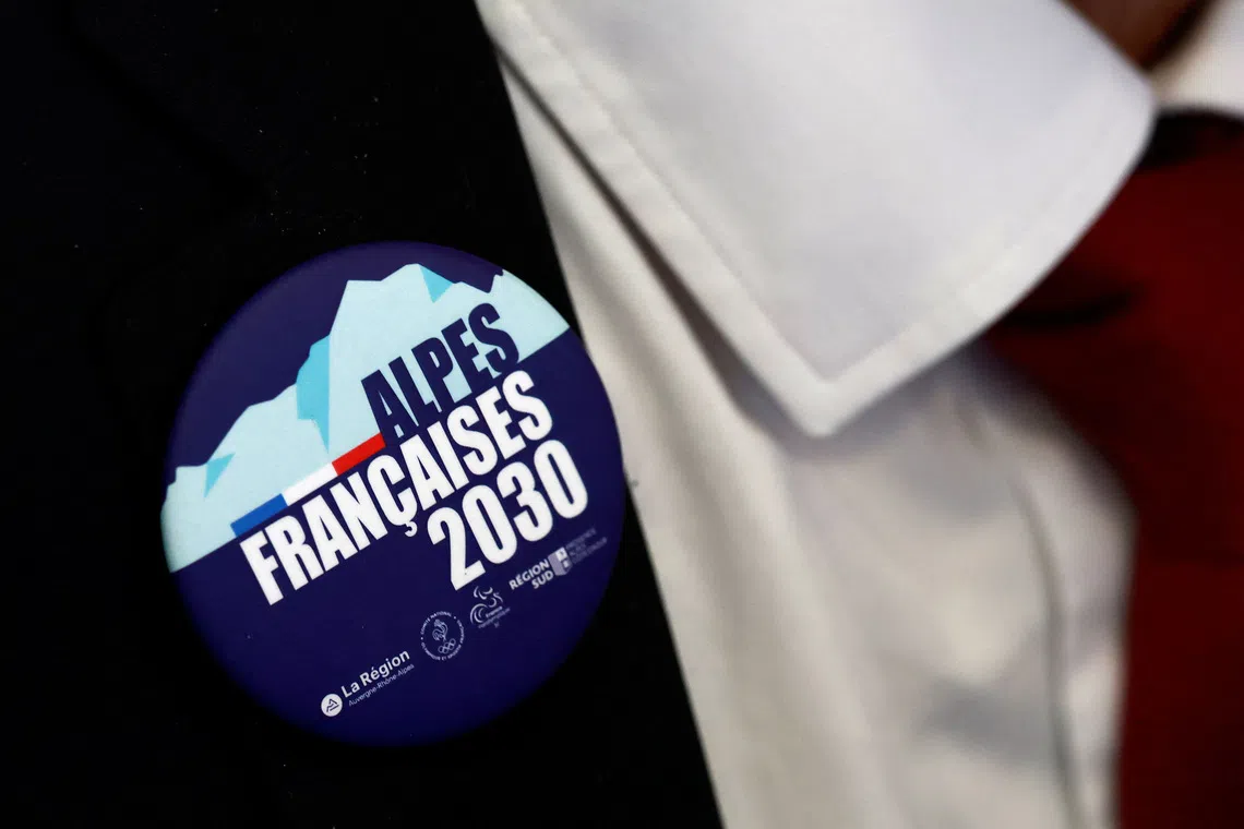 A man wears a badge with the logo \"French Alps 2030\" during the press conference of the launch of the Organizing Commitee for the 2030 French Alps Olympic and Paralympic Winter Games in Lyon, France, February 18, 2025. REUTERS/Manon Cruz