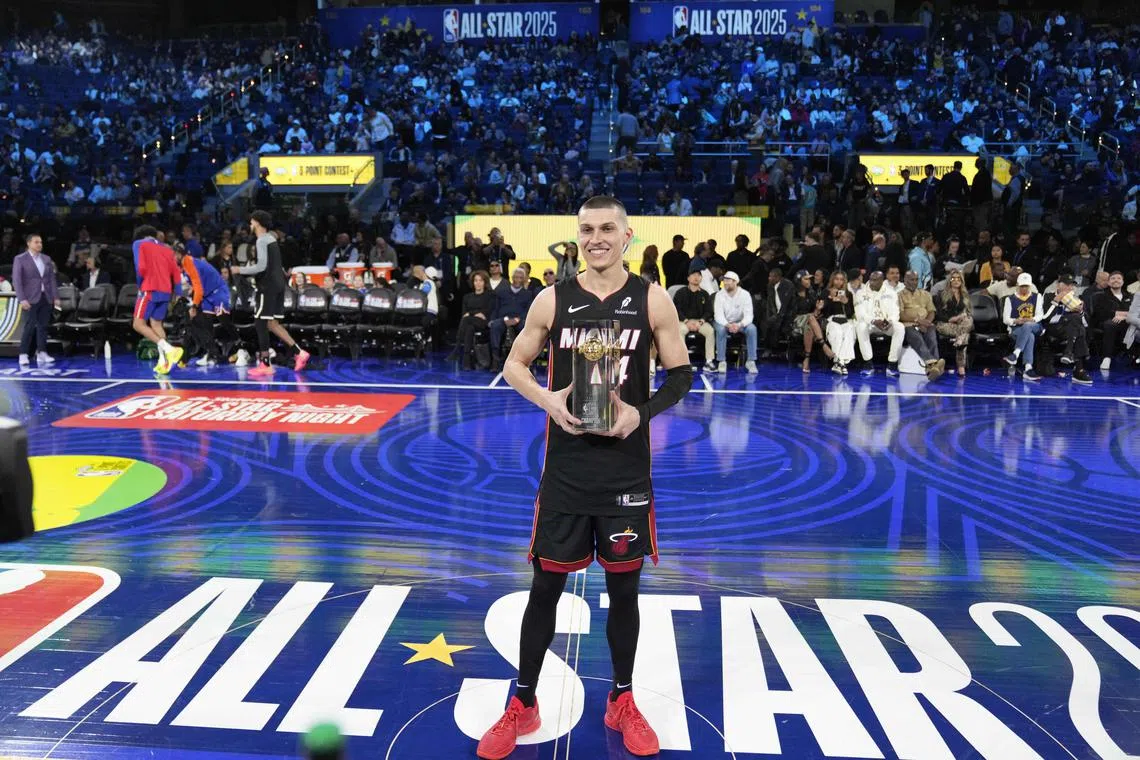 Miami Heat guard Tyler Herro celebrates with the trophy after winning the three-point contest during All Star Saturday Night.