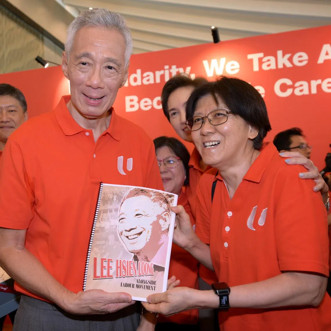 PM Lee Hsien Loong receiving a gift from Ms Ng Yuen Jiuan from the Ong Teng Cheong Labour Leadership Institute at the May Day Rally on May 1.