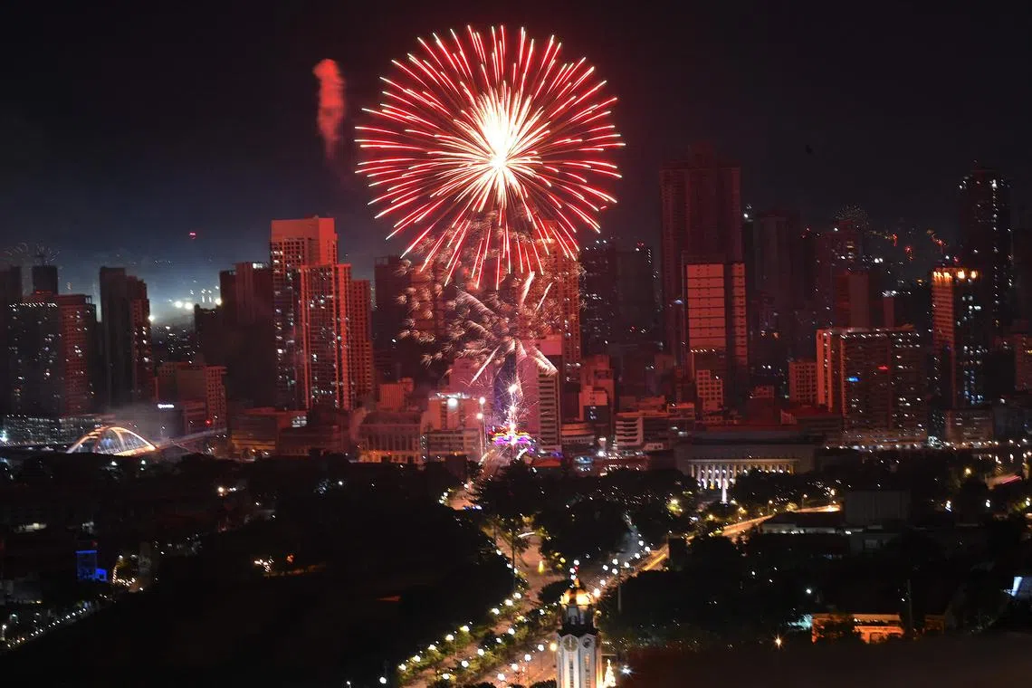 Fireworks light up the sky over Jones Bridge in Manila to  celebrate during New Year celebrations on Jan 1, 2023. 