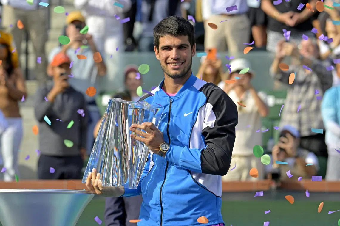 Carlos Alcaraz with the championship trophy after defeating Daniil Medvedev in the men’s final of the BNP Paribas open at the Indian Wells Tennis Garden. 