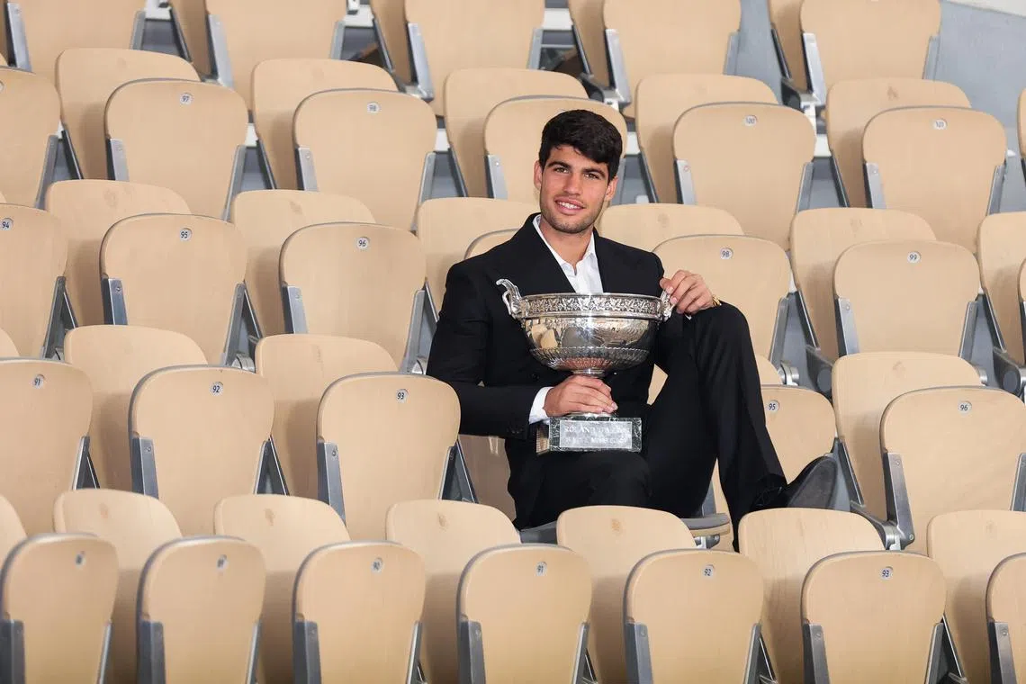 Carlos Alcaraz of Spain posing with the Coupe des Mousquetaires trophy for winning the men's singles final at the French Open Grand Slam tennis tournament at Roland Garros on June 10.