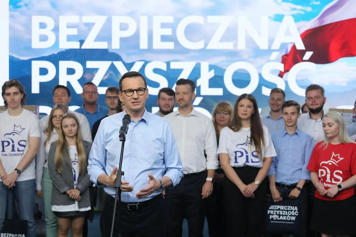 Polish Prime Minister Mateusz Morawiecki speaks during a press conference at PiS headquarters in Warsaw.