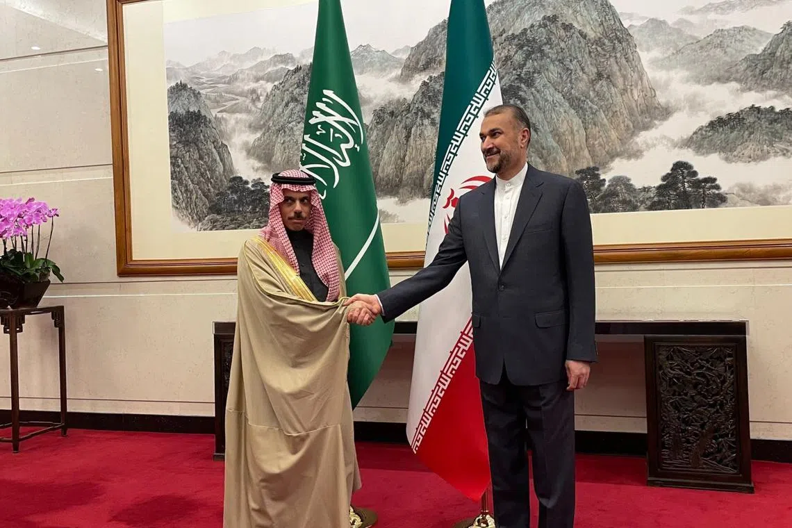 Saudi's Prince Faisal bin Farhan Al Saud greets his Iranian counterpart, Mr Hossein Amirabdollahian. 
