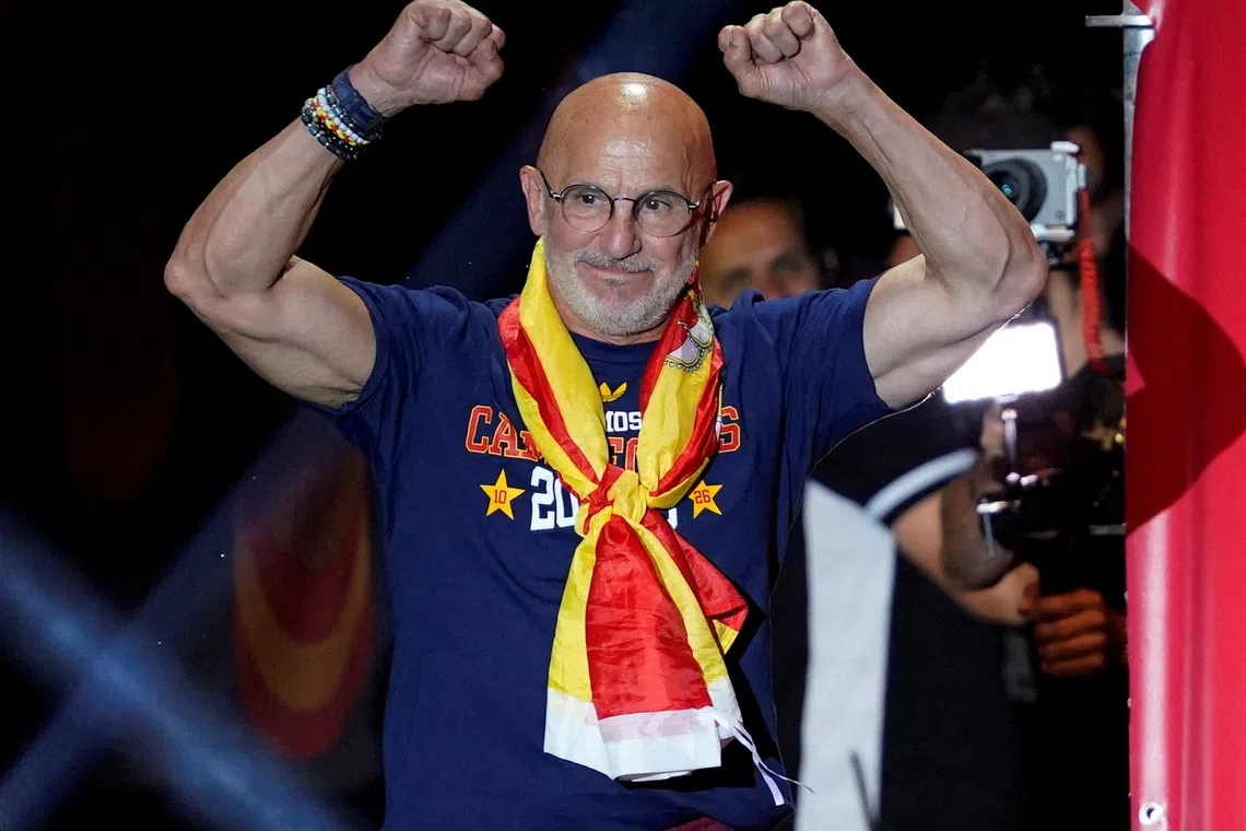 Soccer Football - FIFA World Cup 2026 - Spain Victory Parade - Madrid, Spain - July 20, 2026 Spain coach Luis De La Fuente celebrates on the stage at Cibeles Square in Madrid after the victory parade as fans gather to celebrate winning the World Cup REUTERS/Ana Beltran