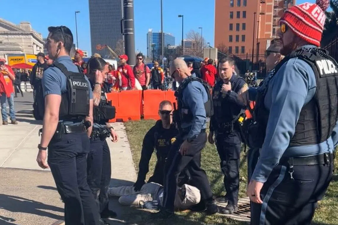 Police officers detain a person outside of Union Station following a shooting near an outdoor celebration of the NFL champion Chiefs' Super Bowl victory, in Kansas City, Missouri, U.S. February 14, 2024 in this screen grab obtained from social media video. Alyssa Contreras/via REUTERS