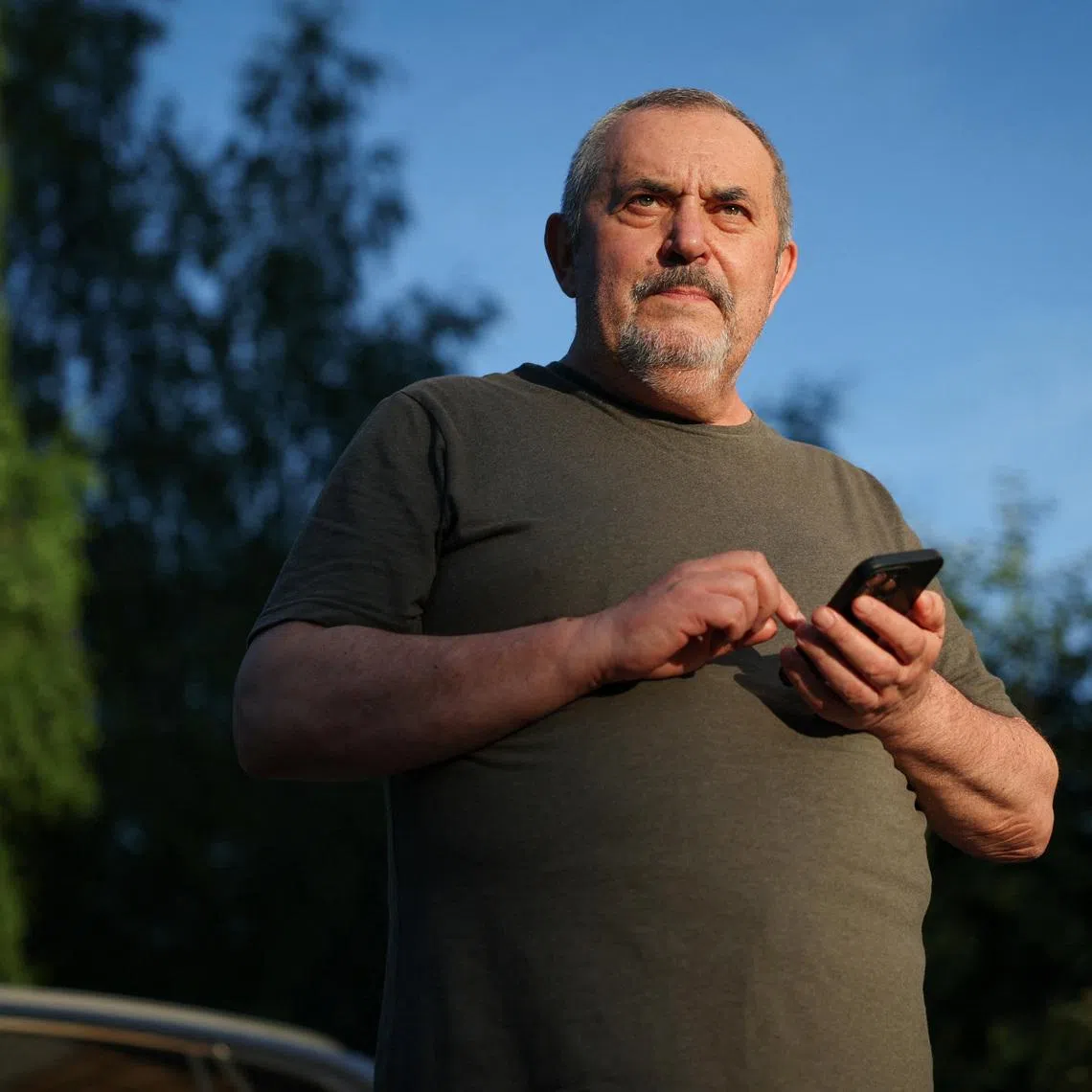 Boris Nadezhdin, an anti-war Russian politician, checks his phone after he has been released from police station in Dolgoprudny, Moscow region, Russia July 13, 2026.  REUTERS/Ramil Sitdikov