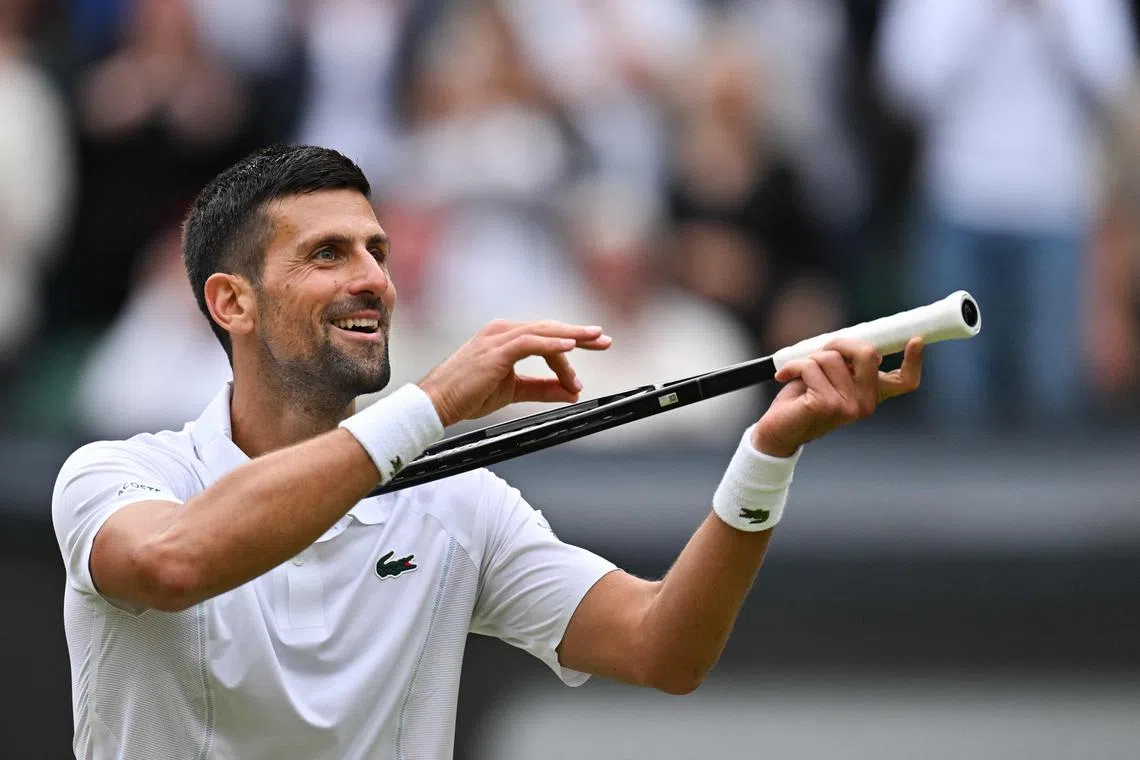 Serbia's Novak Djokovic imitates playing the violin with his racket as he celebrates beating Italy's Lorenzo Musetti during their men's singles semi-final at The All England Lawn Tennis and Croquet Club in Wimbledon on July 12. He will face Carlos Alcaraz in the final on July 14.