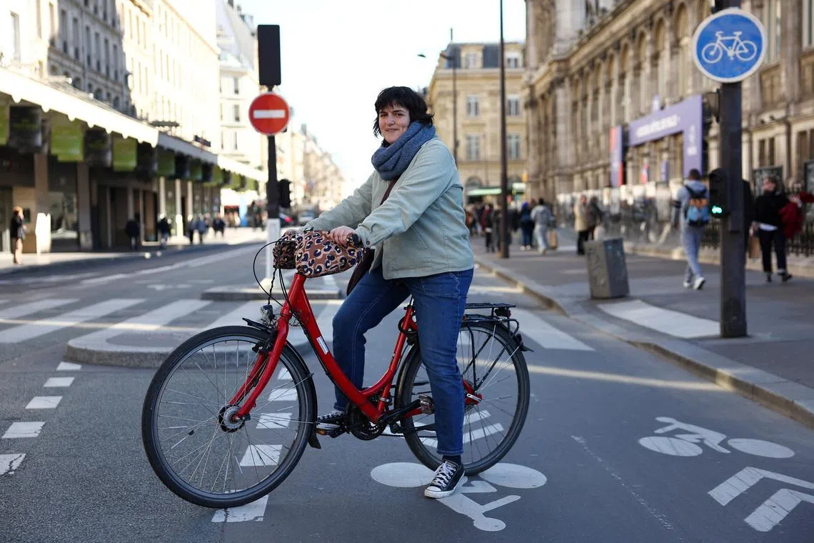 Parisian bike enthousiast Marion Soulet, of the Paris en Selle association, poses on a bicycle path after an interview with Reuters in Paris, France, March 2, 2026. REUTERS/Abdul Saboor