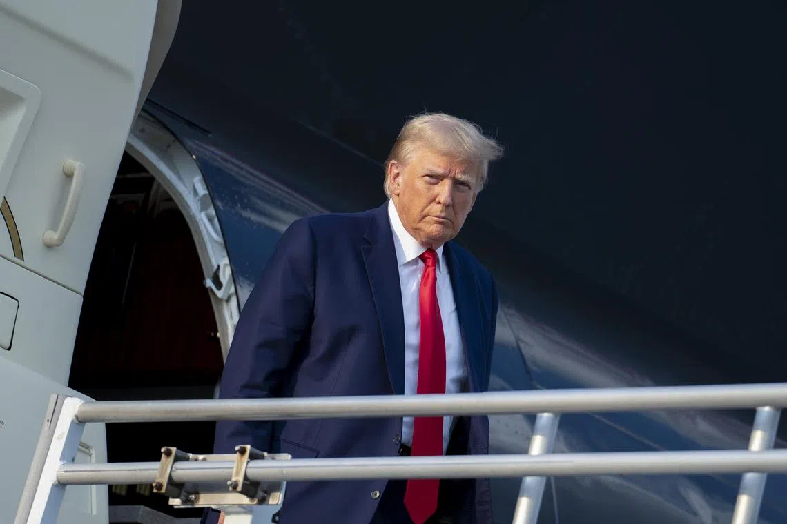 Donald Trump exits his private plane after arriving in Atlanta on  Aug 24 to turn himself in at the Fulton County Jail.